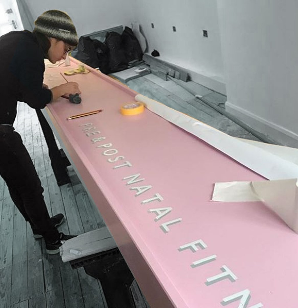 Minimalist Chic painting a shop sign NGS